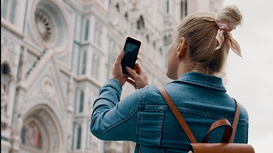 Photo of a lady taking a photo of a cathedral