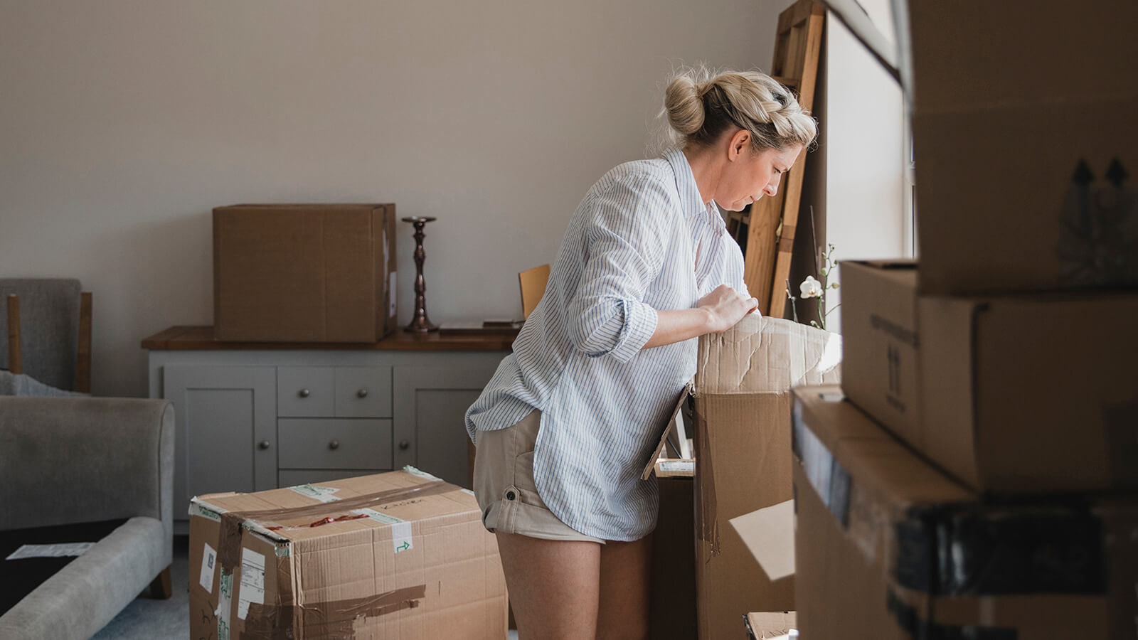 Lady unpacking boxes